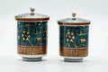 Both lidded teacups, lids on, front view.
