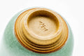 Underside of the cup, showing the gold-painted foot and maker's mark.
