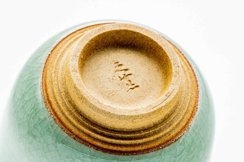 Underside of the cup, showing the gold-painted foot and maker's mark.
