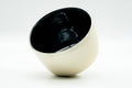 Angled overhead view into the chawan revealing the glossy black interior glaze