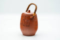 Three-quarter angled view highlighting the engraved Egyptian-style motifs around the body.