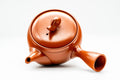 Close-up of the seated pig figurine that forms the lid knob.