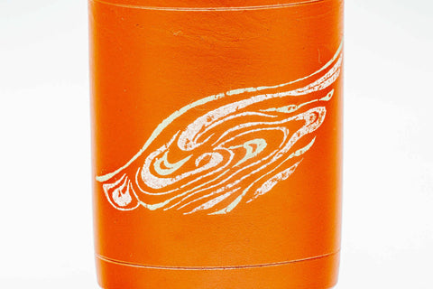Close-up of a single cup detailing the swirling design on the red clay.