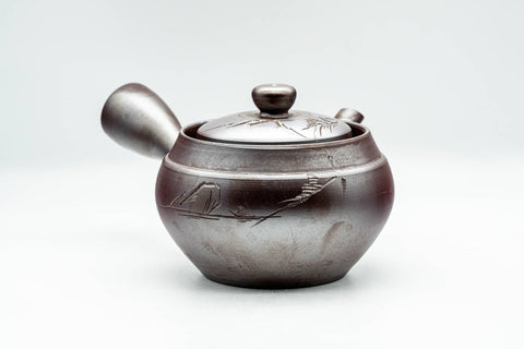 Opposite side view of the Banko teapot showing the engraved landscape decoration