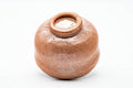 Bowl tilted to show the unglazed foot and base.