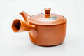 Red shudei Tokoname kyusu, side profile with the spout to the left
