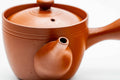 Side view of the red kyusu showing the spout, lid on.