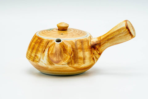 Front view of the yellow ribbed Arita-yaki kyusu teapot with its lid on and short side handle