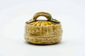Front view of the basket-weave kogo with the lid on and a loop handle on top.