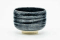 Black metallic chawan, front view showing the dark banded glaze