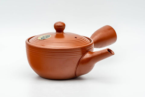 Japanese Kyusu - Spiraling Red Shudei Tokoname-yaki Mesh Teapot - 250ml - three-quarter view with the spout to the left and side handle to the right, showing the spiral-ridged body
