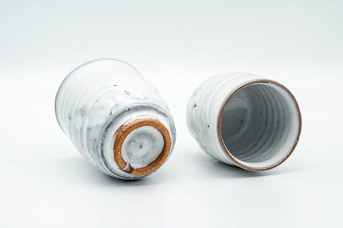 Tezumi — Japanese Teacups - Pair of Milky White Glazed Wavy Meoto Yunomi — three-quarter view