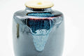 Overhead view of the chaire showing the blue drip glaze and ivory lid from above.