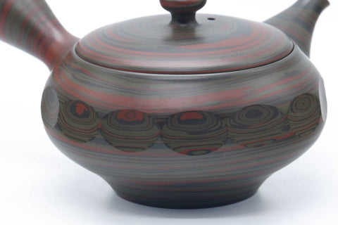 Another angle showing the faceted body and marbled clay.