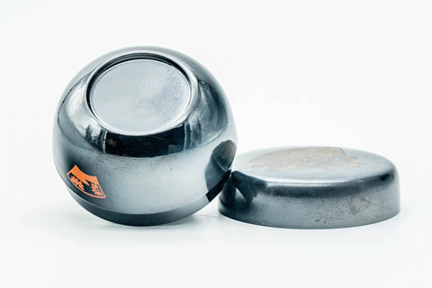 Black-lacquer floral matcha tea caddy with body and lid lying down separated, three-quarter view