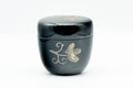 Japanese Natsume - Gold Floral Black Lacquer Matcha Tea Caddy - 80ml - closed caddy at a three-quarter angle showing the gold butterfly-and-floral design