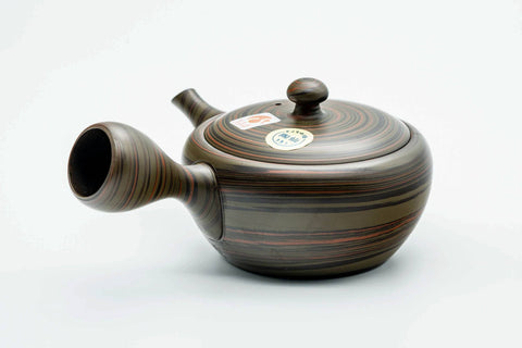 Dark green nerikomi Tokoname kyusu, three-quarter view from the opposite side with the spout to the right