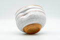Japanese Teacup - Akiyama Kiln Milky White Glazed Thumb-Indented Yunomi - 150ml - tilted view showing the unglazed footring