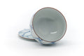 The lid removed and propped beside the tilted cup, revealing the glazed interior.