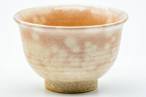 Close-up of a single yunomi showing the pink gohonte blush and Hagi glaze.
