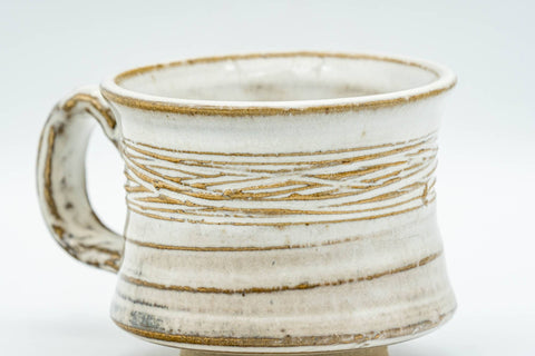 Tezumi — Japanese Teacup - Carved Exterior White Glazed Rear-Handled Ushirode Yunomi - 110ml — tipped to show the interior