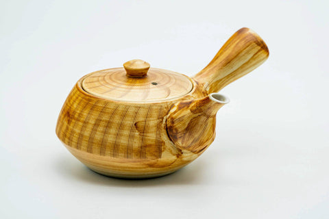 Three-quarter view of the yellow-brown kyusu with the lid on.