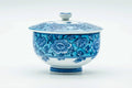 Slightly angled view of the lidded blue-floral cup.