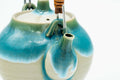 Top-down view of the turquoise Agano-yaki teapot showing the lid's navel-shaped knob and turquoise drip