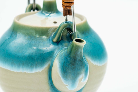 Top-down view of the turquoise Agano-yaki teapot showing the lid's navel-shaped knob and turquoise drip