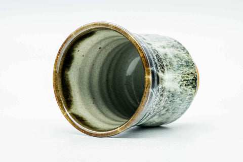The cup tilted forward to reveal the glazed interior and rim.