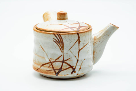 Shino-glazed kyusu teapot alone, front view, showing the spout, lid, and side handle.