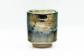 The yunomi tilted slightly to reveal the rim and glazed interior.