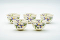 Japanese Teacups - Set of 5 Kozan Kiln Purple Floral Mino-yaki Porcelain Yunomi - the five white porcelain cups grouped together, decorated with purple floral motifs, three-quarter view