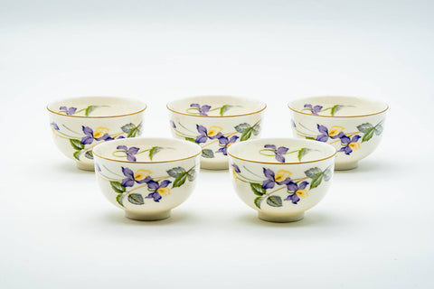 Japanese Teacups - Set of 5 Kozan Kiln Purple Floral Mino-yaki Porcelain Yunomi - the five white porcelain cups grouped together, decorated with purple floral motifs, three-quarter view