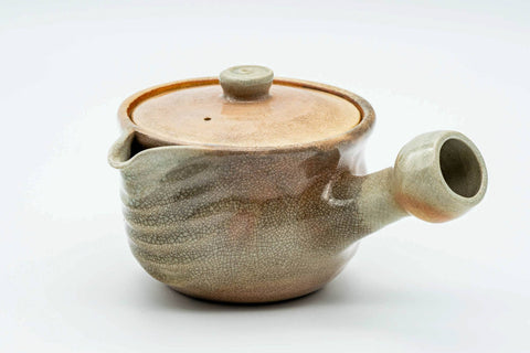 Beige weathered Hagi-yaki kyusu, three-quarter view from the rear with the spout to the right