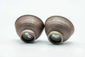 The pair with one cup tipped to show the foot.
