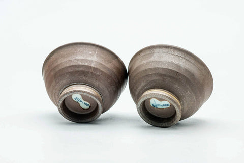 The pair with one cup tipped to show the foot.