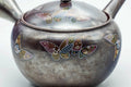 Three-quarter view showing the floral motif and spout of the banko kyusu.