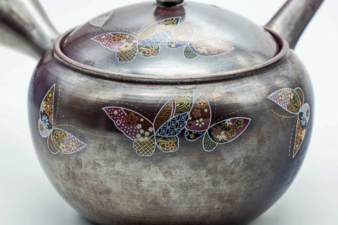 Three-quarter view showing the floral motif and spout of the banko kyusu.