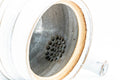 Interior of the teapot with the lid off, showing the integrated ceramic mesh filter at the base of the spout.