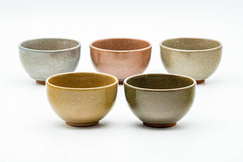 The five cups arranged together, showing the range of celadon glaze colors.
