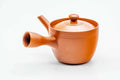 Side view of the red kyusu with the handle to the left, lid on.