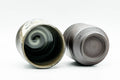The two cups inverted, showing the dark glossy swirled glaze on their interiors and bases.