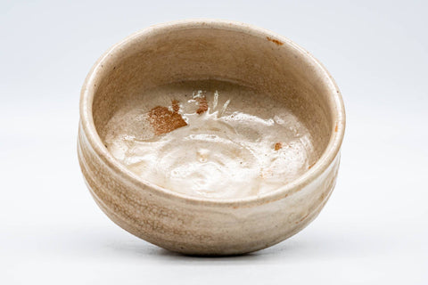 Overhead view into the bowl revealing patches of glaze crawling on the interior.