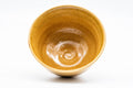 Overhead view into the Ki-Seto bowl, showing the spiralling interior and pooled yellow glaze at the well.