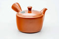 Red shudei Tokoname kyusu, three-quarter view with the spout to the right and handle to the left