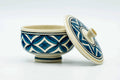 Blue-and-white Kutani-yaki teacup with a diamond-lattice pattern, lid leaning beside it.