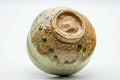 Tilted view of the Shigaraki chawan showing the foot and stony textured base