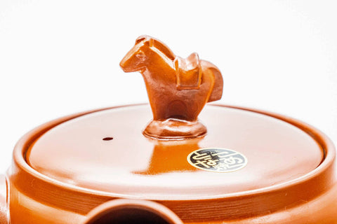 Closeup of the sculpted horse figurine forming the lid knob of the red shudei kyusu