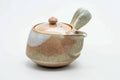 Tsubaki Kiln beige-pink weathered Hagi-yaki side-handle kyusu teapot, three-quarter view with lid on